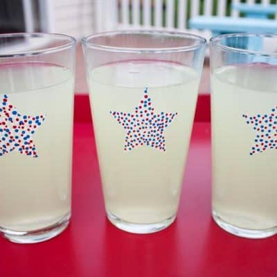 Summer Star Glasses - a fun new addition to your cookout! via createcraftlove.com #glasspaint #summer #4thofjuly #pointillism