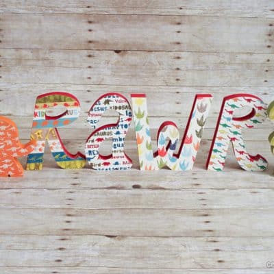 Mod Podge Wooden Dinosaur Letters via createcraftlove.com #modpodge #woodenletters #artsychaos #dinosaurs