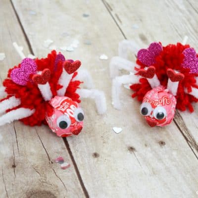 Using Valentine Tootsie Pops, I created these Love Bug Pops for the kiddo to pass out to his classmates! via createcraftlove.com #valentinesday #pompom #valentineideas #kidsproject