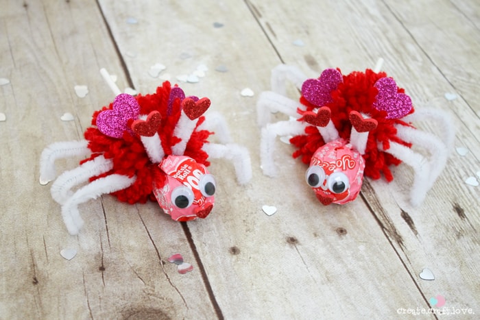 Using Valentine Tootsie Pops, I created these Love Bug Pops for the kiddo to pass out to his classmates! via createcraftlove.com #valentinesday #pompom #valentineideas #kidsproject