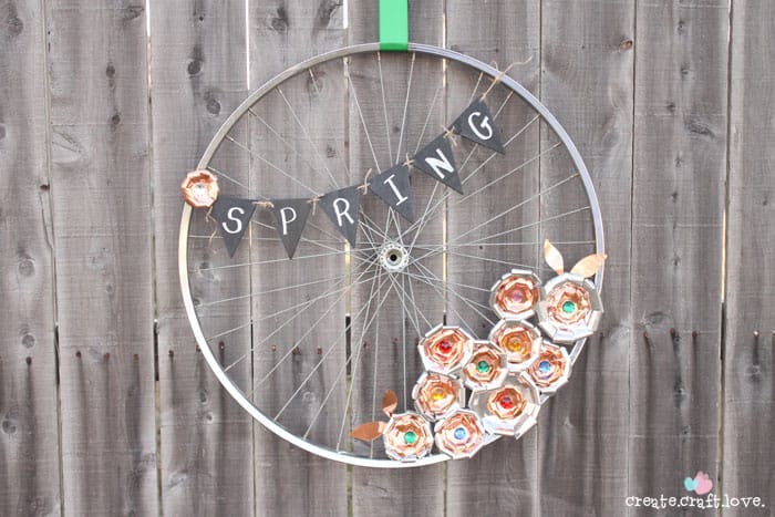 Create this Metal Flower Bicycle Wheel Wreath with a little help from the Cricut Explore! #explorecricut #wreath #spring #decor
