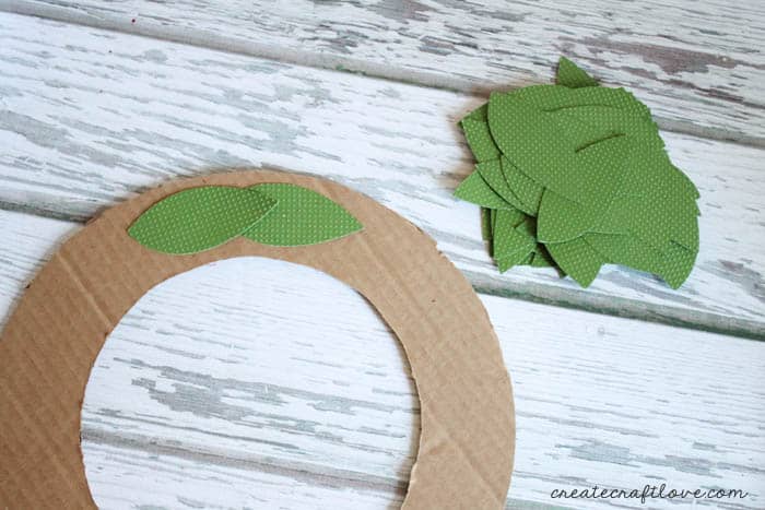 add leaves to cardboard ring