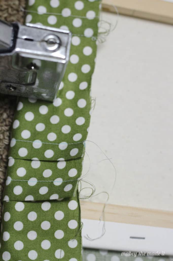 staple edges of pintucked canvas