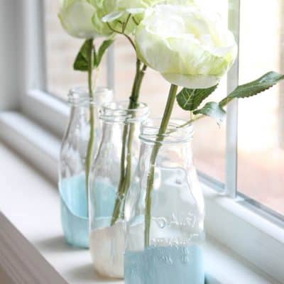 These Paint Dipped Milk Bottles makes beautiful bud vases for your fresh flowers! via createcraftlove.com