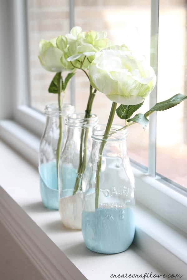 These Paint Dipped Milk Bottles makes beautiful bud vases for your fresh flowers! via createcraftlove.com
