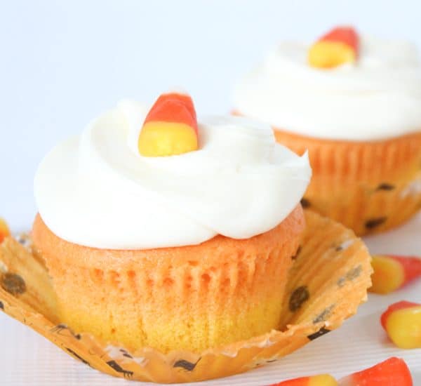 You don't have to be a fan of candy corn to love these vanilla Candy Corn Cupcakes! via createcraftlove.com