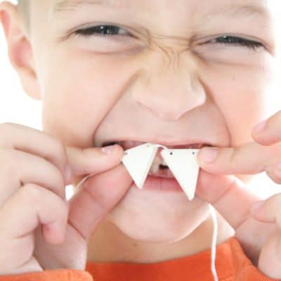 This DIY Fang Necklace is a fun kid's craft for Halloween! via createcraftlove.com