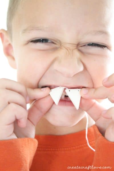 This DIY Fang Necklace is a fun kid's craft for Halloween! via createcraftlove.com