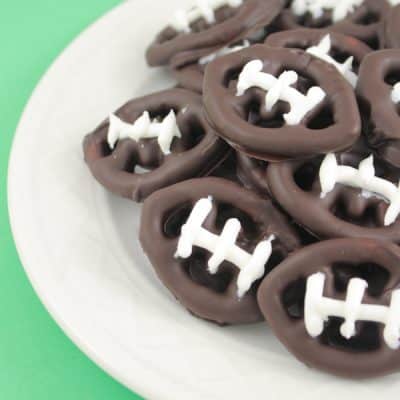 These bite sized chocolate covered football pretzels make perfect Super Bowl Party Treats! via createcraftlove.com