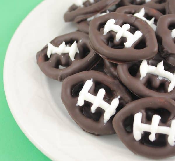 These bite sized chocolate covered football pretzels make perfect Super Bowl Party Treats! via createcraftlove.com