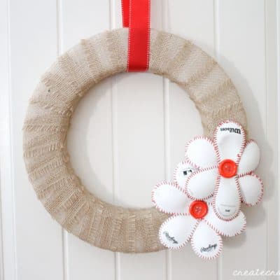 This Baseball Wreath complete with baseball flowers is the best way to welcome spring (training)! via createcraftlove.com