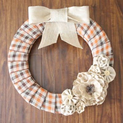 This Burlap and Plaid Fall Wreath is the perfect way to greet guests this autumn!