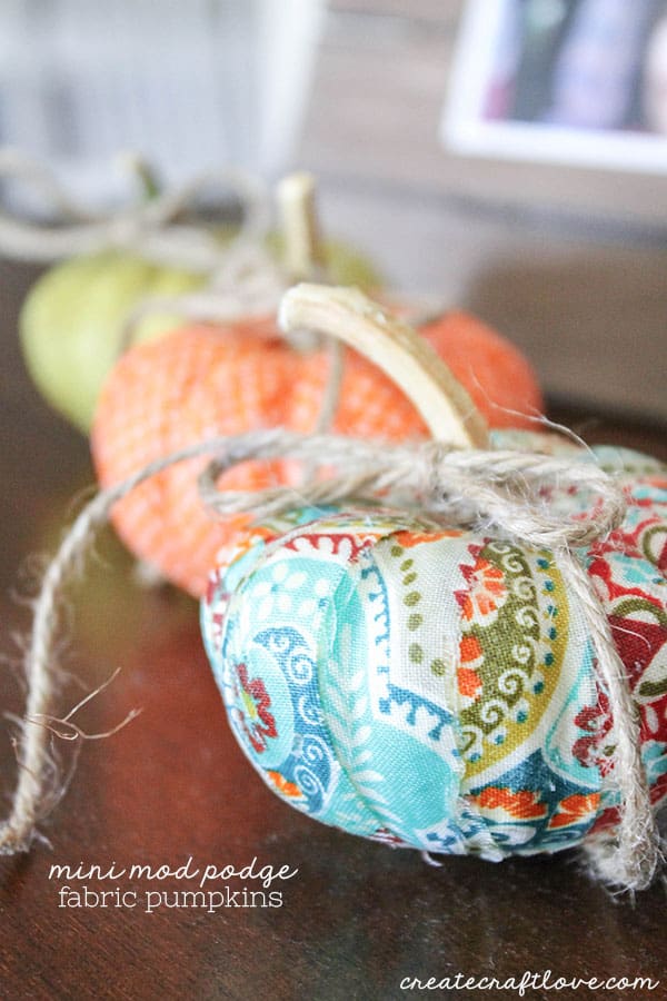 These Mini Mod Podge Fabric Pumpkins are a bright and colorful way to add to your fall decor!
