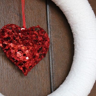 This Yarn Wrapped Valentine Wreath is easy to make and can be used for other seasons! via createcraftlove.com