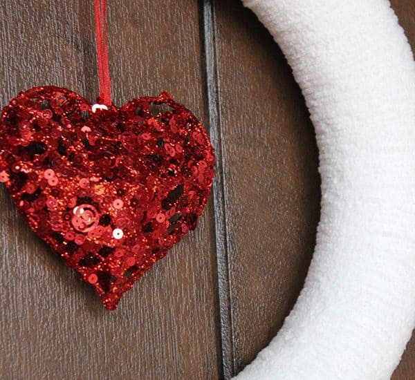 This Yarn Wrapped Valentine Wreath is easy to make and can be used for other seasons! via createcraftlove.com