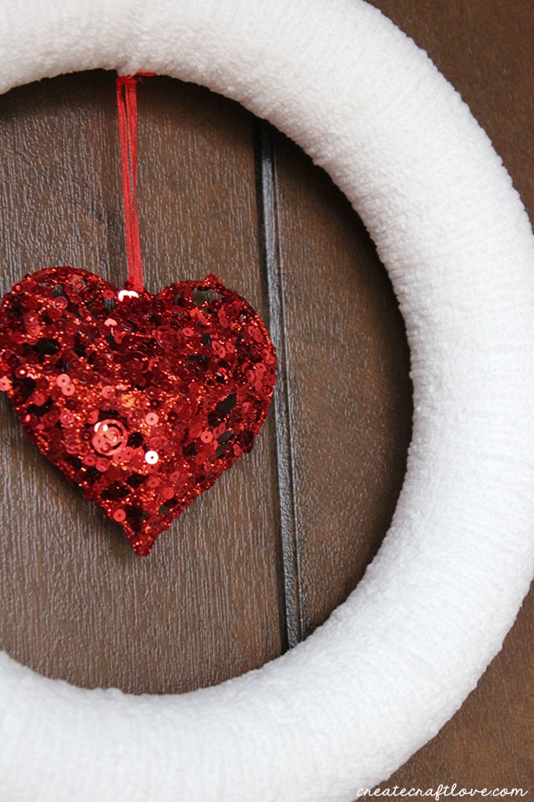 This Yarn Wrapped Valentine Wreath is easy to make and can be used for other seasons! via createcraftlove.com