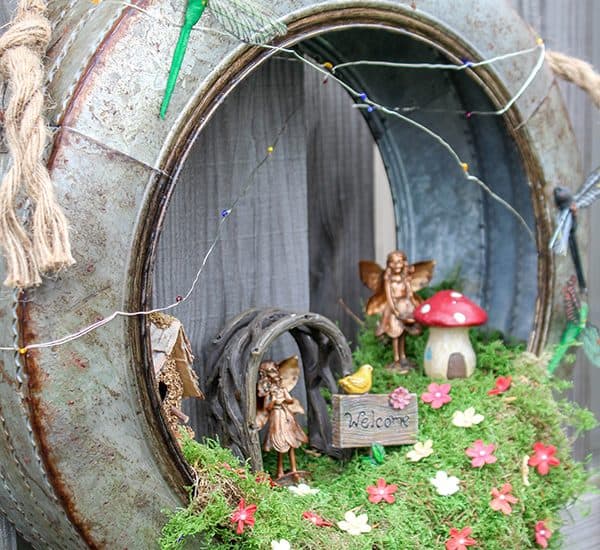 Create a whimsical fairy habitat to welcome spring!  This Fairy Garden Wreath will impress any guest! #ad #hobbylobbystyle #hobbylobbymade