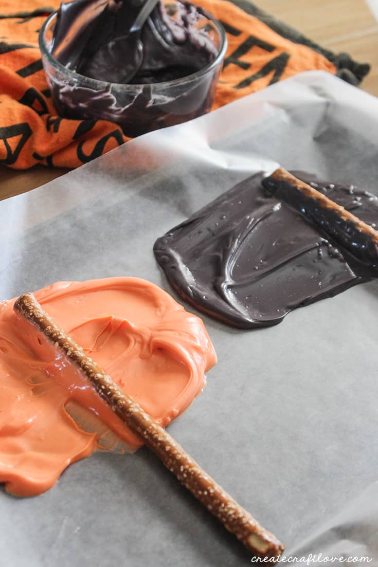 Dipping your Halloween Chocolate Covered Pretzels