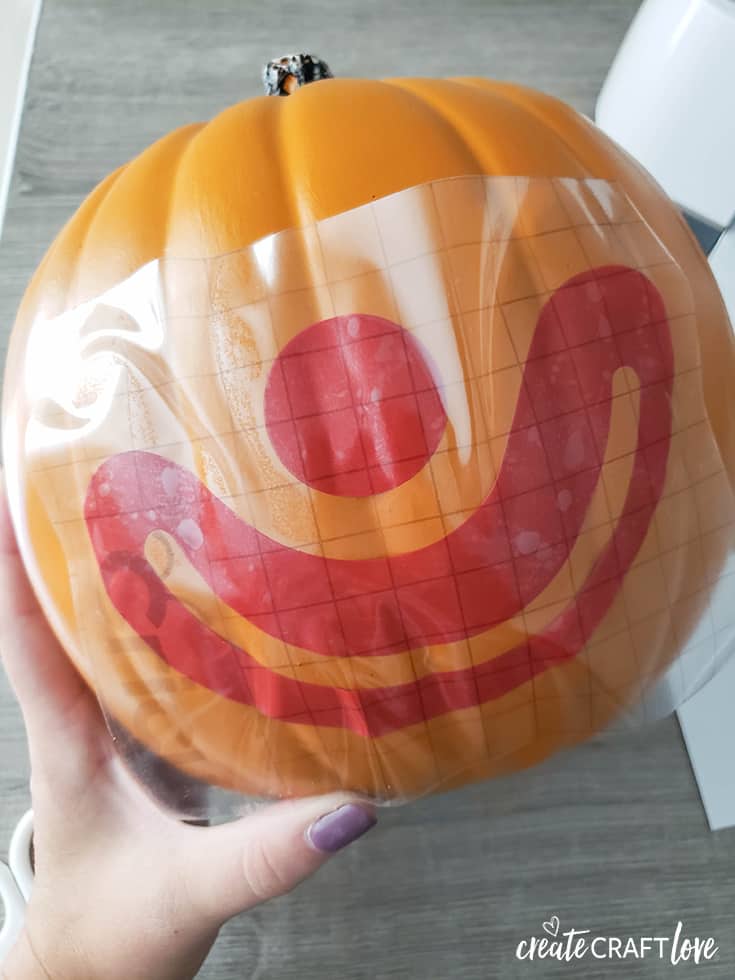 apply vinyl face to pumpkin